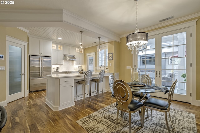 dining area with visible vents, dark wood-style flooring, and french doors