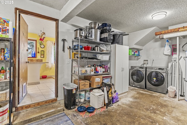 laundry room with washer and clothes dryer, laundry area, and a textured ceiling