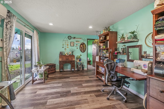 office area featuring recessed lighting, a textured ceiling, baseboards, and wood finished floors