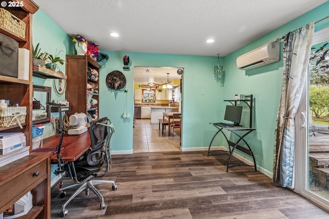 office with recessed lighting, a wall mounted AC, baseboards, and wood finished floors