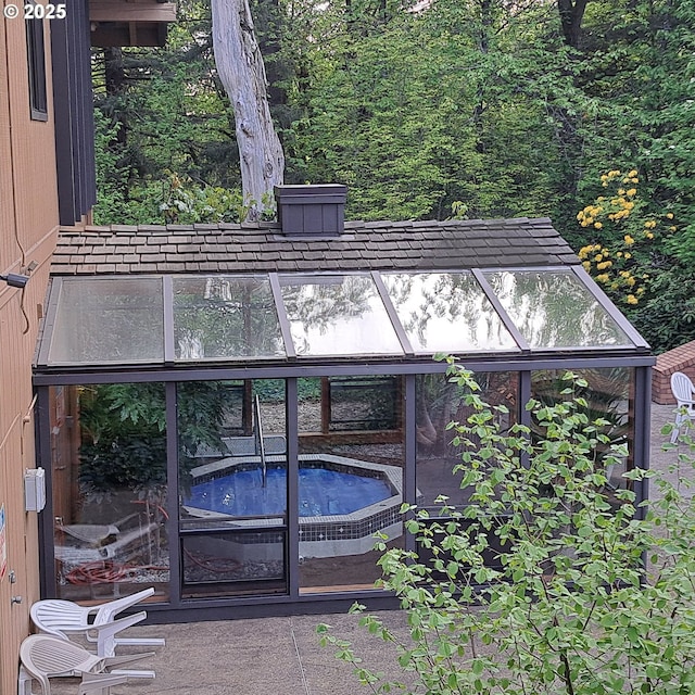 exterior space featuring a hot tub