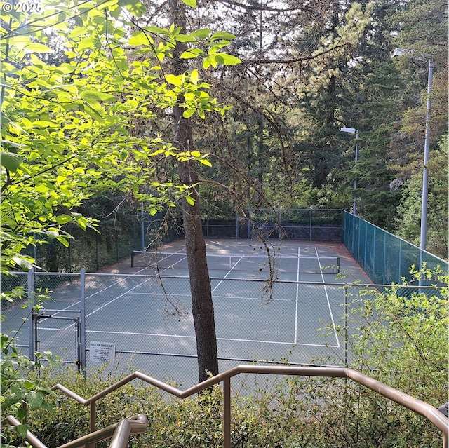 view of tennis court with fence