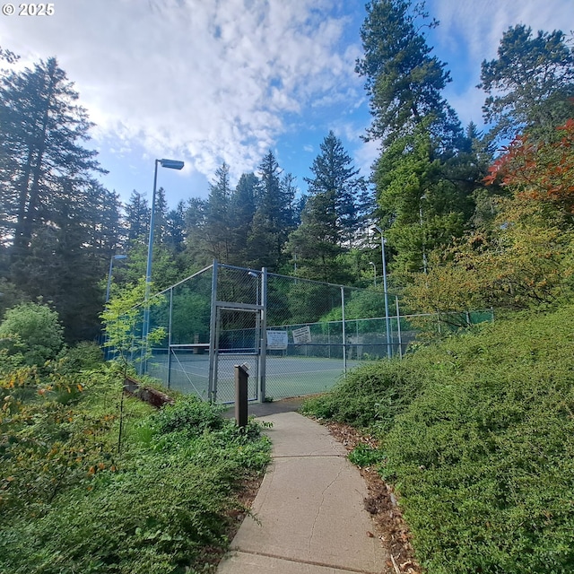 view of sport court featuring a gate and fence
