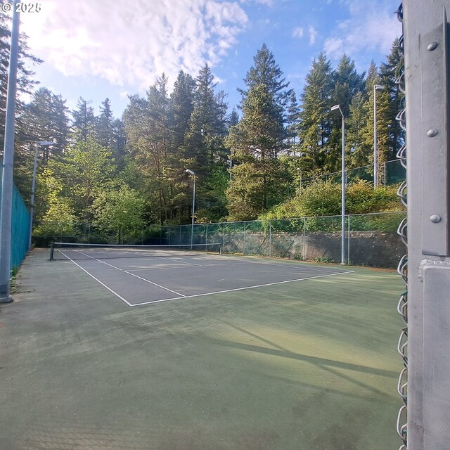 view of sport court with fence