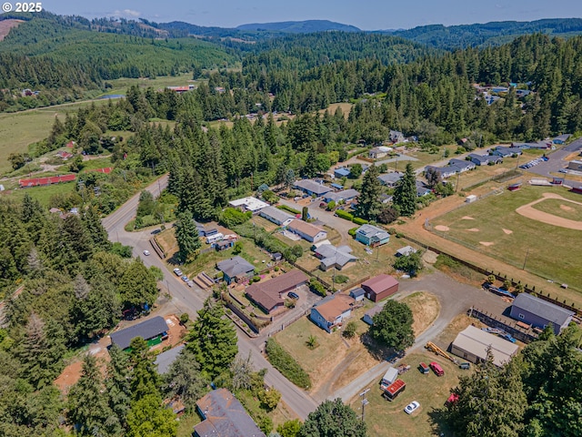 1446 N Collier St, Coquille, OR 97423 - aerial overview of property's location featuring a heavily wooded area