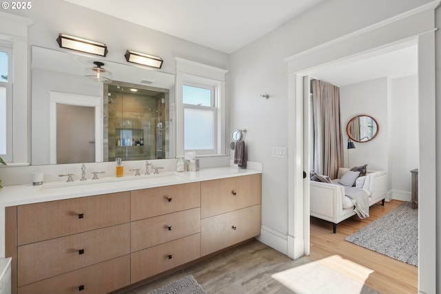 bathroom featuring vanity, an enclosed shower, and hardwood / wood-style flooring