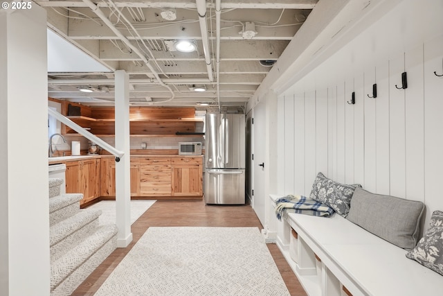 mudroom featuring sink and hardwood / wood-style floors