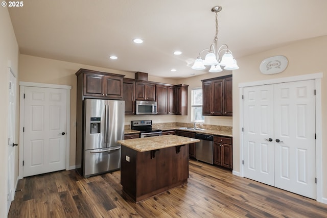 14146 Brittany Ter, Oregon City, OR 97045 - kitchen featuring stainless steel appliances, dark brown cabinets, a chandelier, a kitchen island, and dark wood-style floors