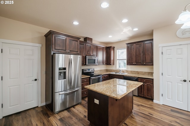 14146 Brittany Ter, Oregon City, OR 97045 - kitchen with stainless steel appliances, a sink, dark brown cabinetry, dark wood-type flooring, and a center island