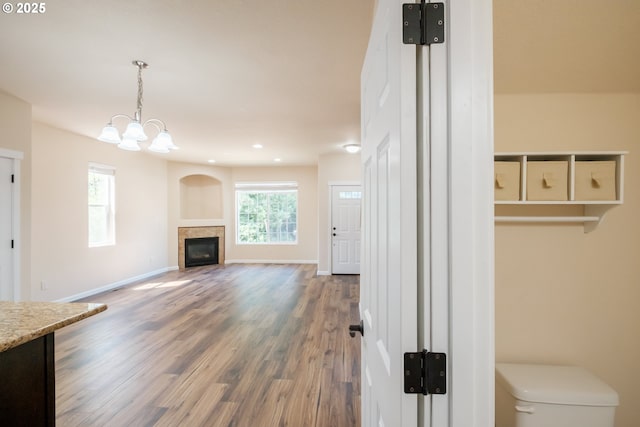 14146 Brittany Ter, Oregon City, OR 97045 - unfurnished living room featuring wood finished floors, a chandelier, a glass covered fireplace, recessed lighting, and baseboards