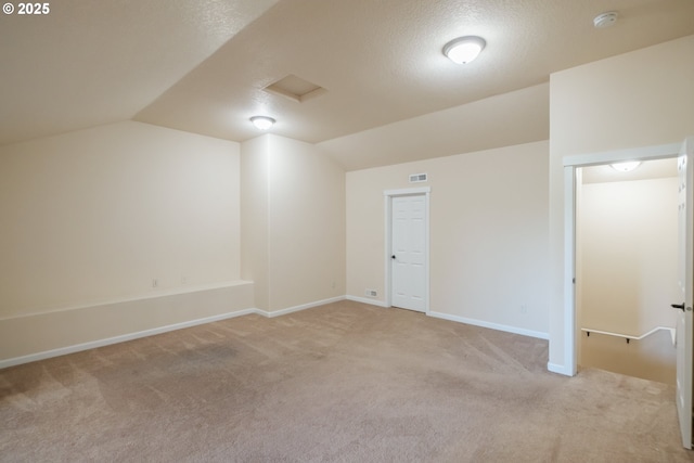 14146 Brittany Ter, Oregon City, OR 97045 - additional living space with light carpet, lofted ceiling, a textured ceiling, and baseboards