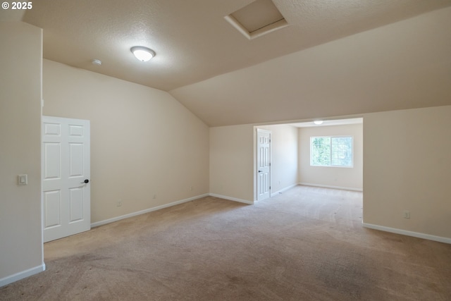 14146 Brittany Ter, Oregon City, OR 97045 - additional living space featuring light carpet, lofted ceiling, a textured ceiling, baseboards, and attic access
