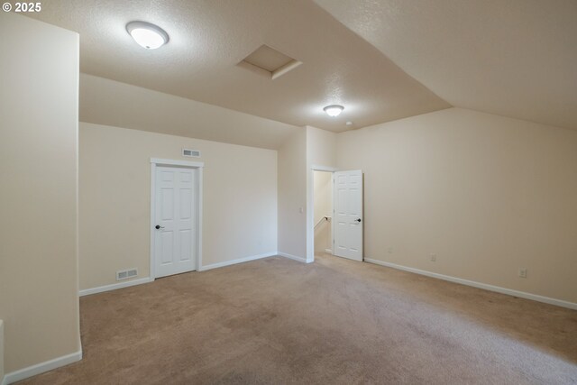 14146 Brittany Ter, Oregon City, OR 97045 - bonus room with lofted ceiling, a textured ceiling, light colored carpet, attic access, and baseboards