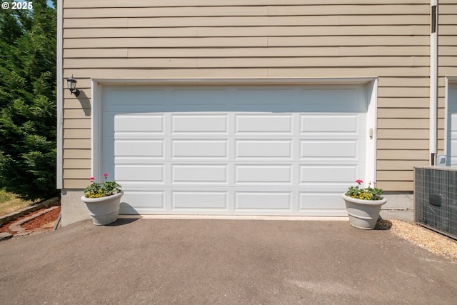 14146 Brittany Ter, Oregon City, OR 97045 - garage featuring asphalt driveway and central air condition unit