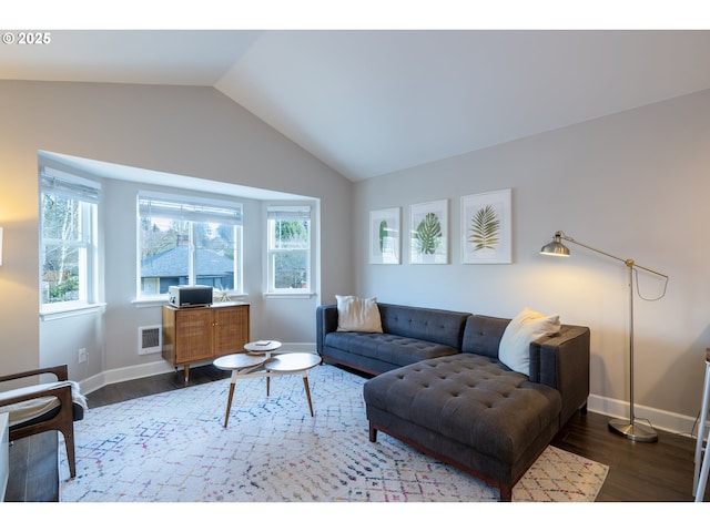 living area with dark wood-style floors, lofted ceiling, and baseboards