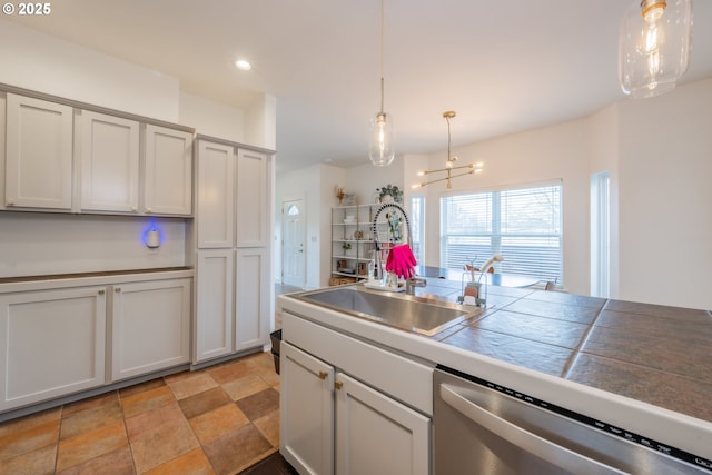 kitchen featuring dishwasher, hanging light fixtures, a sink, and recessed lighting