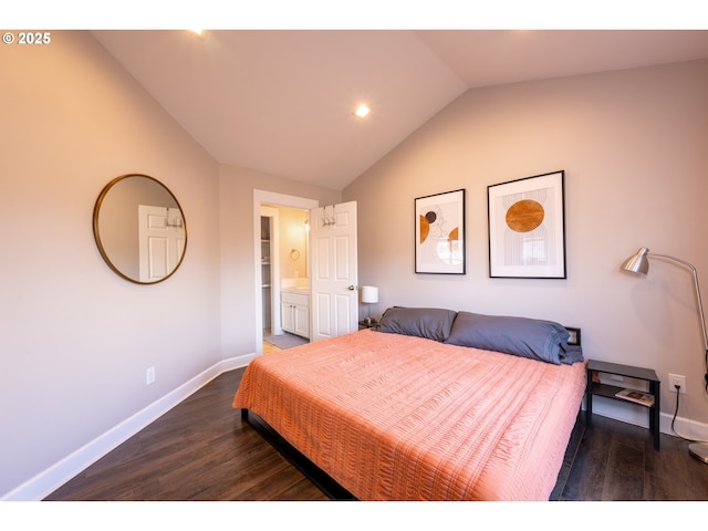 bedroom featuring lofted ceiling, dark wood-style flooring, ensuite bath, and baseboards