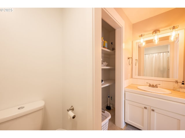 bathroom featuring vanity and toilet