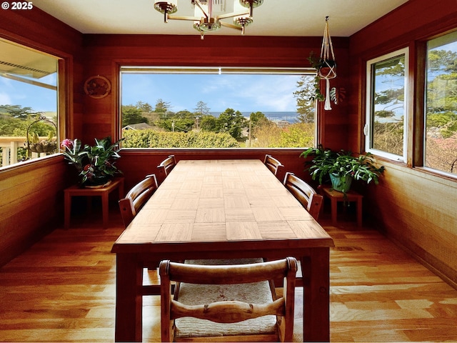 dining area featuring wood finished floors and a chandelier
