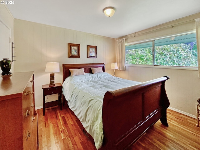 bedroom featuring baseboards and wood finished floors