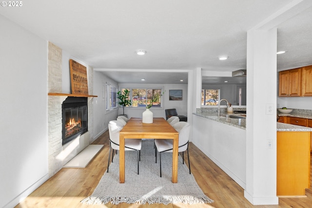 10095 SW 82nd Ave, Portland, OR 97223 - dining room with a fireplace, light wood-style floors, and recessed lighting