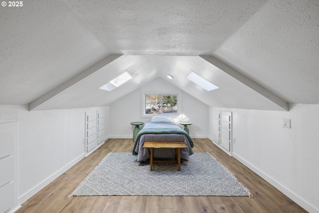 10095 SW 82nd Ave, Portland, OR 97223 - bedroom with a skylight, a textured ceiling, lofted ceiling, wood finished floors, and baseboards