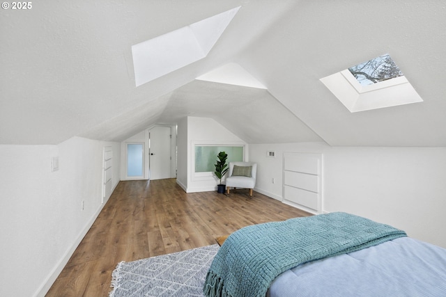 10095 SW 82nd Ave, Portland, OR 97223 - bedroom featuring a skylight, wood finished floors, vaulted ceiling, and baseboards