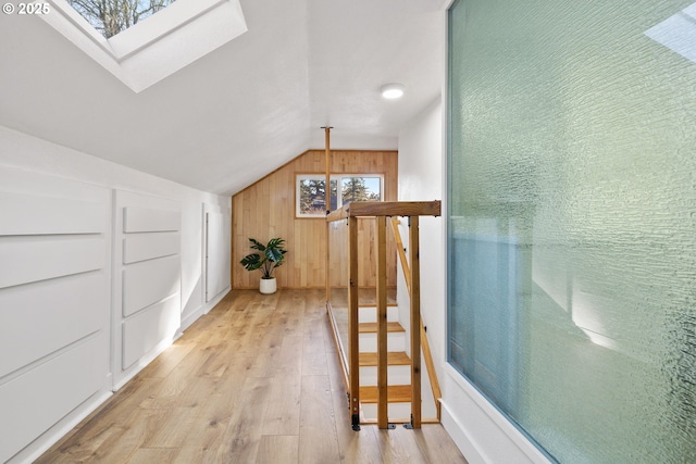 10095 SW 82nd Ave, Portland, OR 97223 - hallway featuring vaulted ceiling, light wood-type flooring, a skylight, and wood walls
