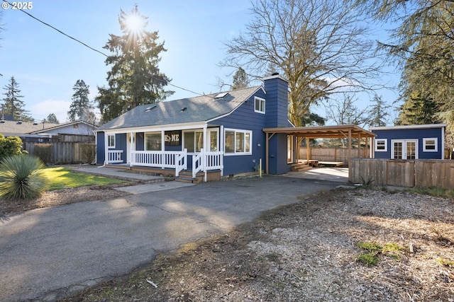 10095 SW 82nd Ave, Portland, OR 97223 - view of front of home with covered porch, asphalt driveway, a carport, a chimney, and a shingled roof