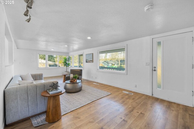 10095 SW 82nd Ave, Portland, OR 97223 - living area with wood-type flooring, a textured ceiling, recessed lighting, and baseboards