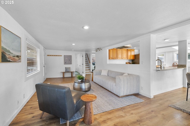 10095 SW 82nd Ave, Portland, OR 97223 - living area featuring stairs, light wood-style floors, recessed lighting, and baseboards