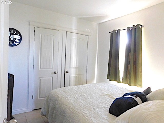 bedroom with light tile patterned floors