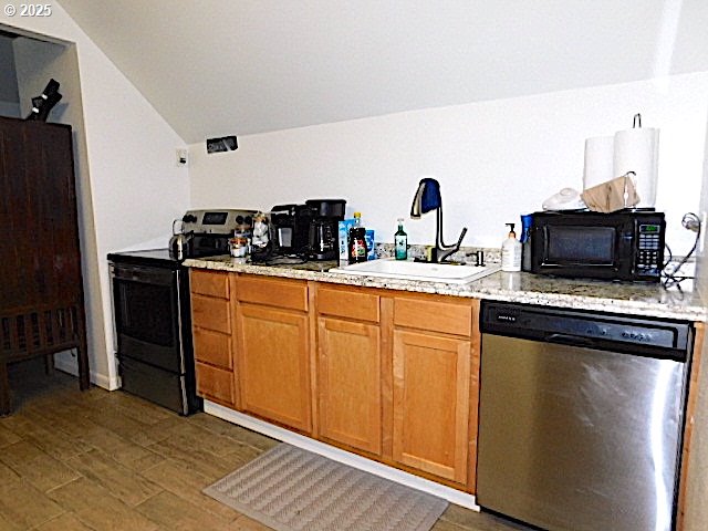 kitchen with sink, dark hardwood / wood-style floors, lofted ceiling, and black appliances