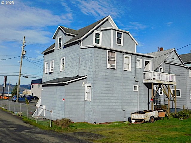 view of side of home with a lawn