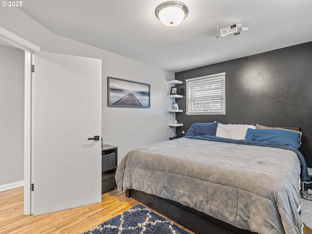 bedroom featuring wood finished floors