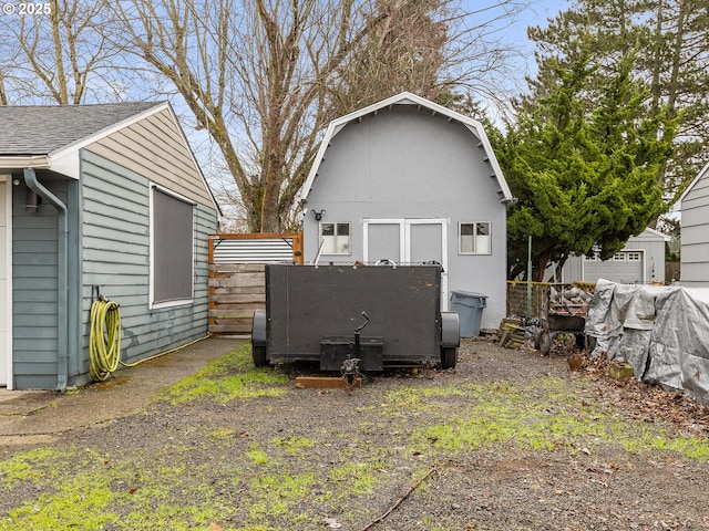 exterior space featuring an outbuilding and fence