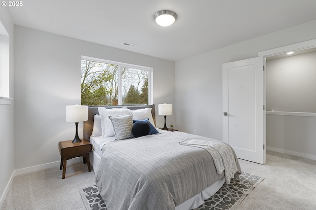 bedroom featuring light colored carpet, visible vents, and baseboards