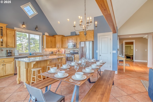 5020 NW Lee Ave, Lincoln City, OR 97367 - dining space with high vaulted ceiling, light tile patterned floors, and a chandelier