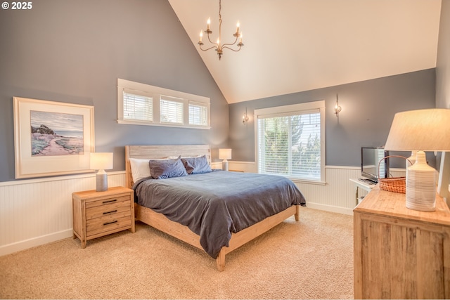 5020 NW Lee Ave, Lincoln City, OR 97367 - bedroom with wainscoting, light colored carpet, a chandelier, and high vaulted ceiling