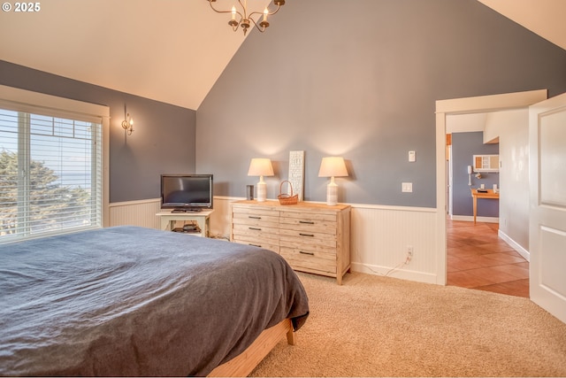 5020 NW Lee Ave, Lincoln City, OR 97367 - carpeted bedroom featuring wainscoting, high vaulted ceiling, a chandelier, and tile patterned floors