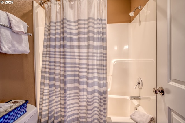 5020 NW Lee Ave, Lincoln City, OR 97367 - bathroom featuring shower / bath combo with shower curtain and a textured wall