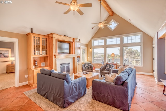 5020 NW Lee Ave, Lincoln City, OR 97367 - living room with ceiling fan, a glass covered fireplace, healthy amount of natural light, beam ceiling, and light tile patterned flooring