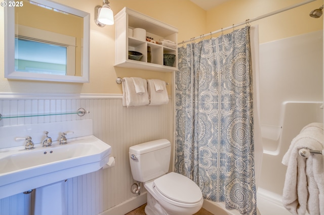 5020 NW Lee Ave, Lincoln City, OR 97367 - full bathroom with a wainscoted wall and shower / bathtub combination with curtain