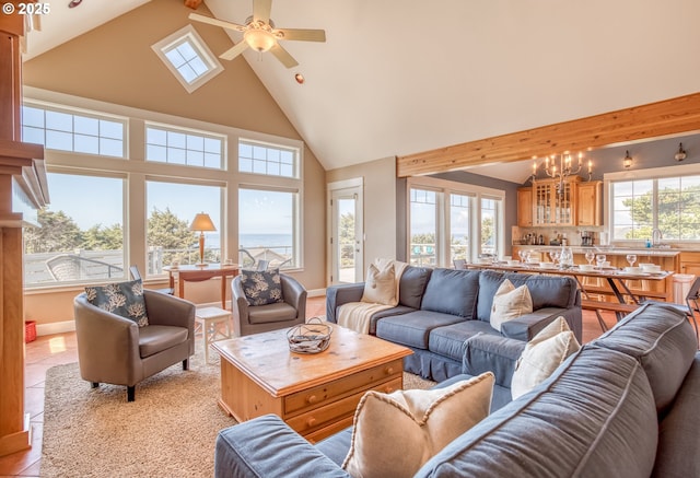 5020 NW Lee Ave, Lincoln City, OR 97367 - living room with high vaulted ceiling, a chandelier, a ceiling fan, and light tile patterned floors