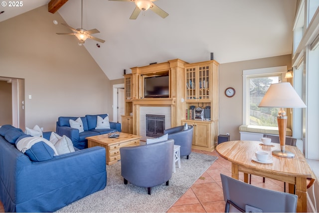 5020 NW Lee Ave, Lincoln City, OR 97367 - living area featuring high vaulted ceiling, a ceiling fan, a fireplace, light tile patterned floors, and beamed ceiling