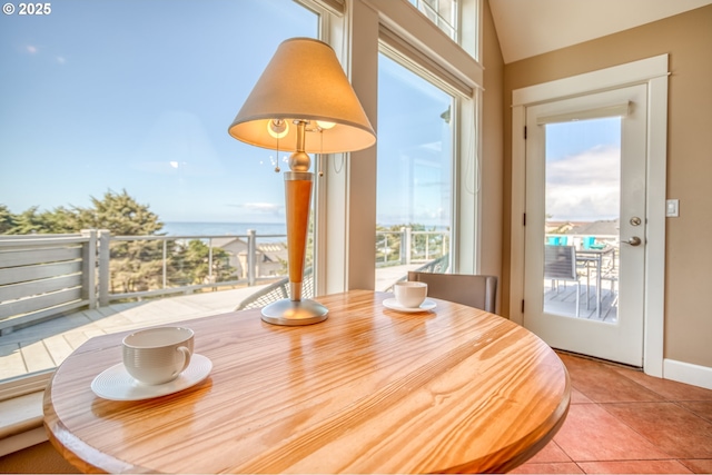 5020 NW Lee Ave, Lincoln City, OR 97367 - dining area featuring plenty of natural light, tile patterned flooring, and lofted ceiling