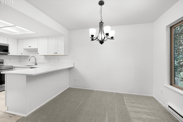 86 Kingsgate Rd Unit D204, Lake Oswego, OR 97035 - kitchen featuring appliances with stainless steel finishes, a baseboard radiator, a chandelier, light countertops, and white cabinetry
