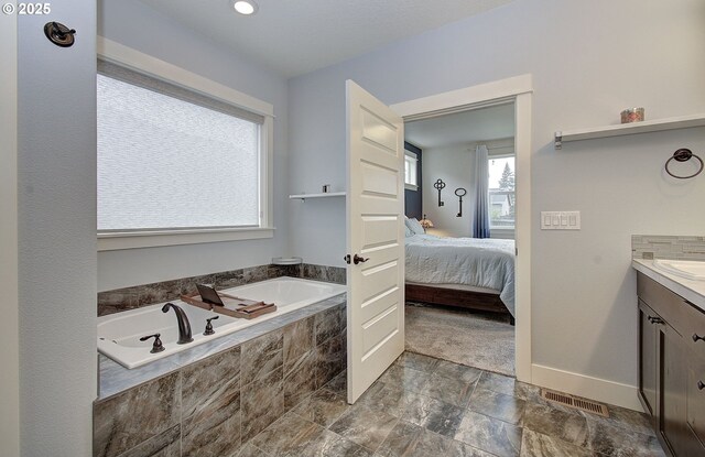 living area featuring a fireplace with flush hearth, recessed lighting, baseboards, and wood finished floors