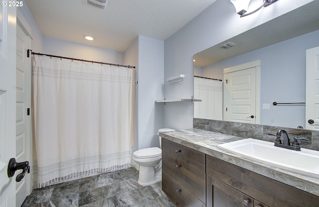 full bathroom with vanity, toilet, visible vents, and a textured ceiling