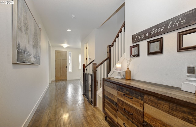 corridor featuring stairway, recessed lighting, baseboards, and wood finished floors